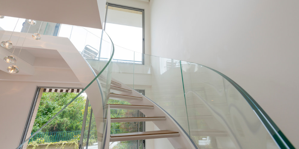 Are Glass Balustrades Safe - an image of a curved frameless glass balustrade staircase